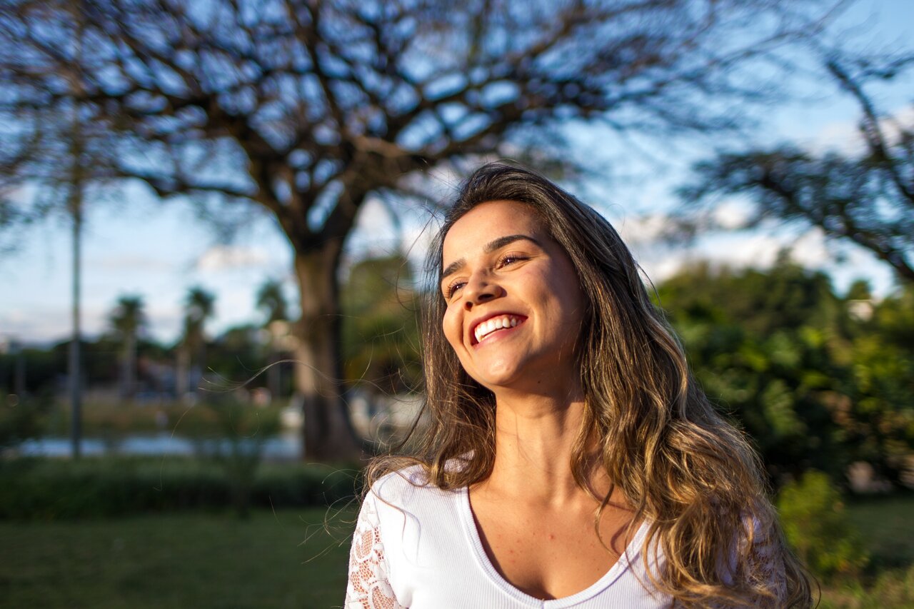 smiling woman wearing a white top