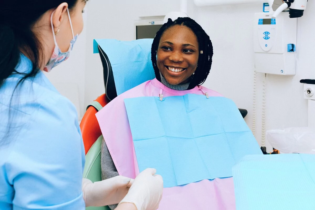 woman smiling in a dentist chair
