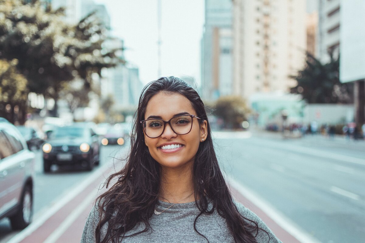 smiling women wearing black glases