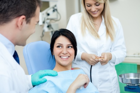 woman consulting with dentist and staff
